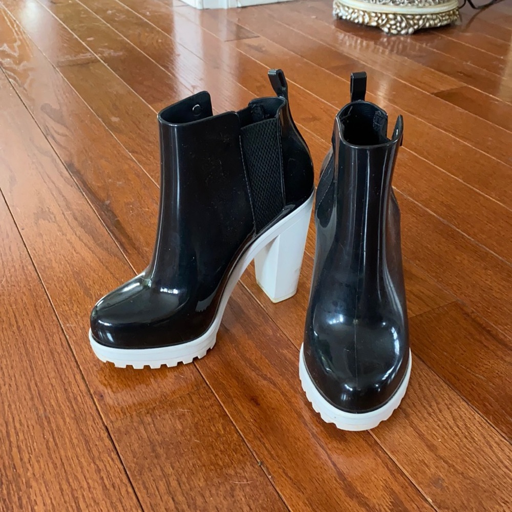 Melissa black boots with white bottoms and heels.